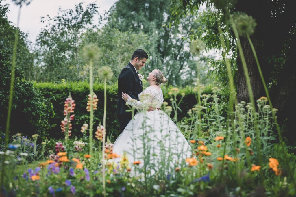 Married couple among the flowers in the secret garden