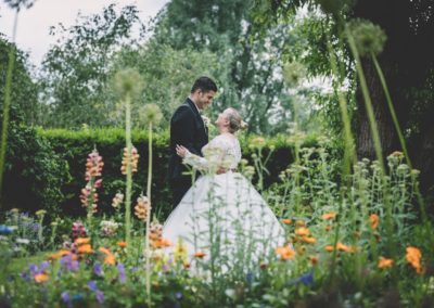 Married couple among the flowers in the secret garden